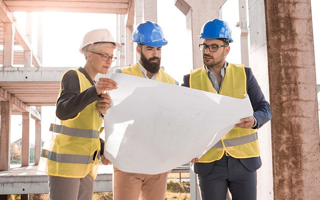 Construction workers reading blueprint